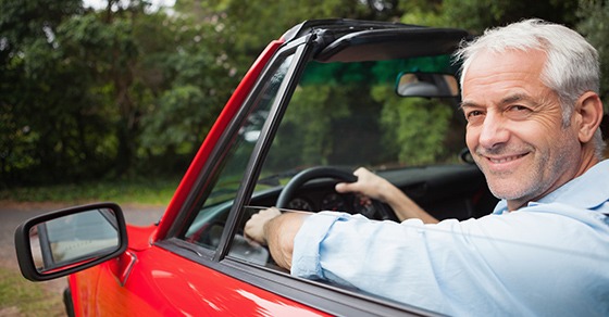 man in a red car