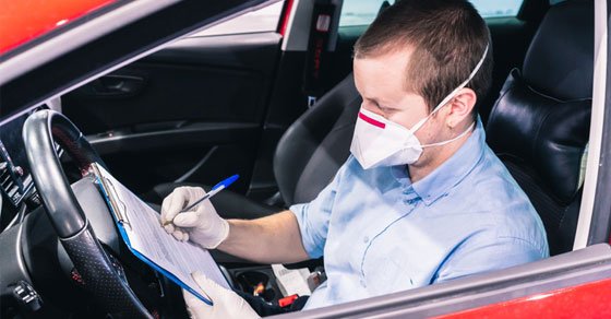 independent contractor wearing a face mask in his car