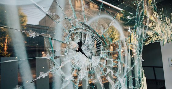 broken store window from rioting and looting