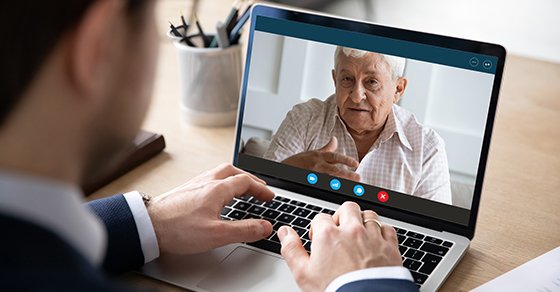 grandson talking to grandfather via zoom over business succession planning