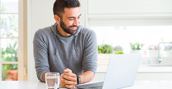 Bearded man working from home with his laptop